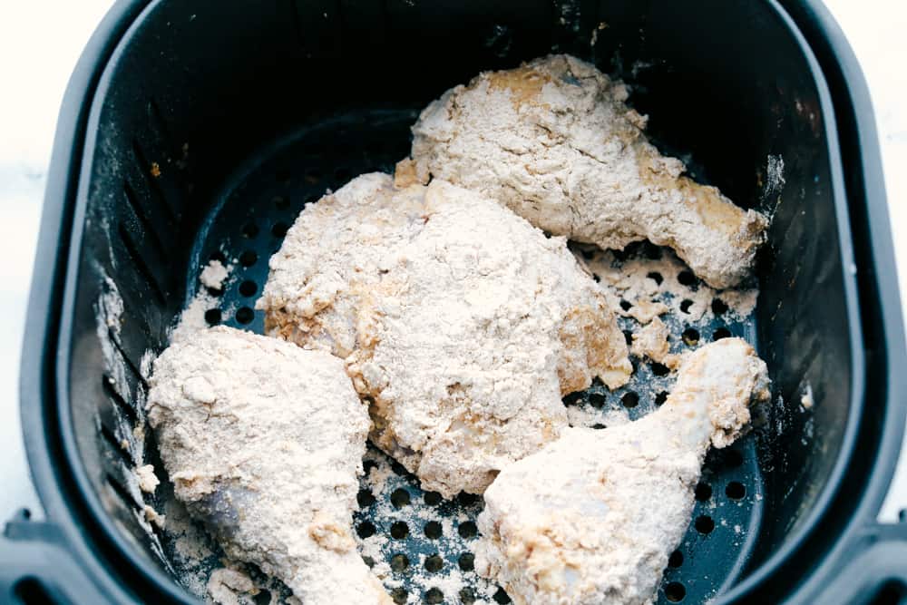 Air fryer full of ready to cook fried chicken. 