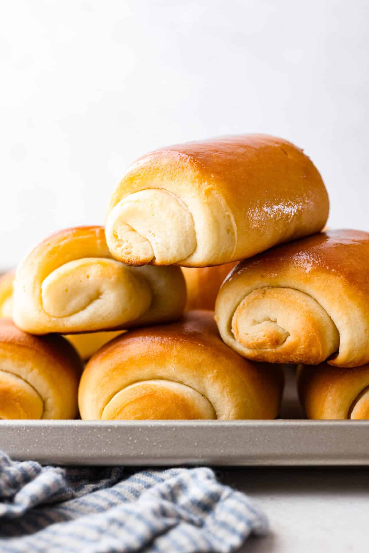 Side shot of a stack of lion house rolls. 