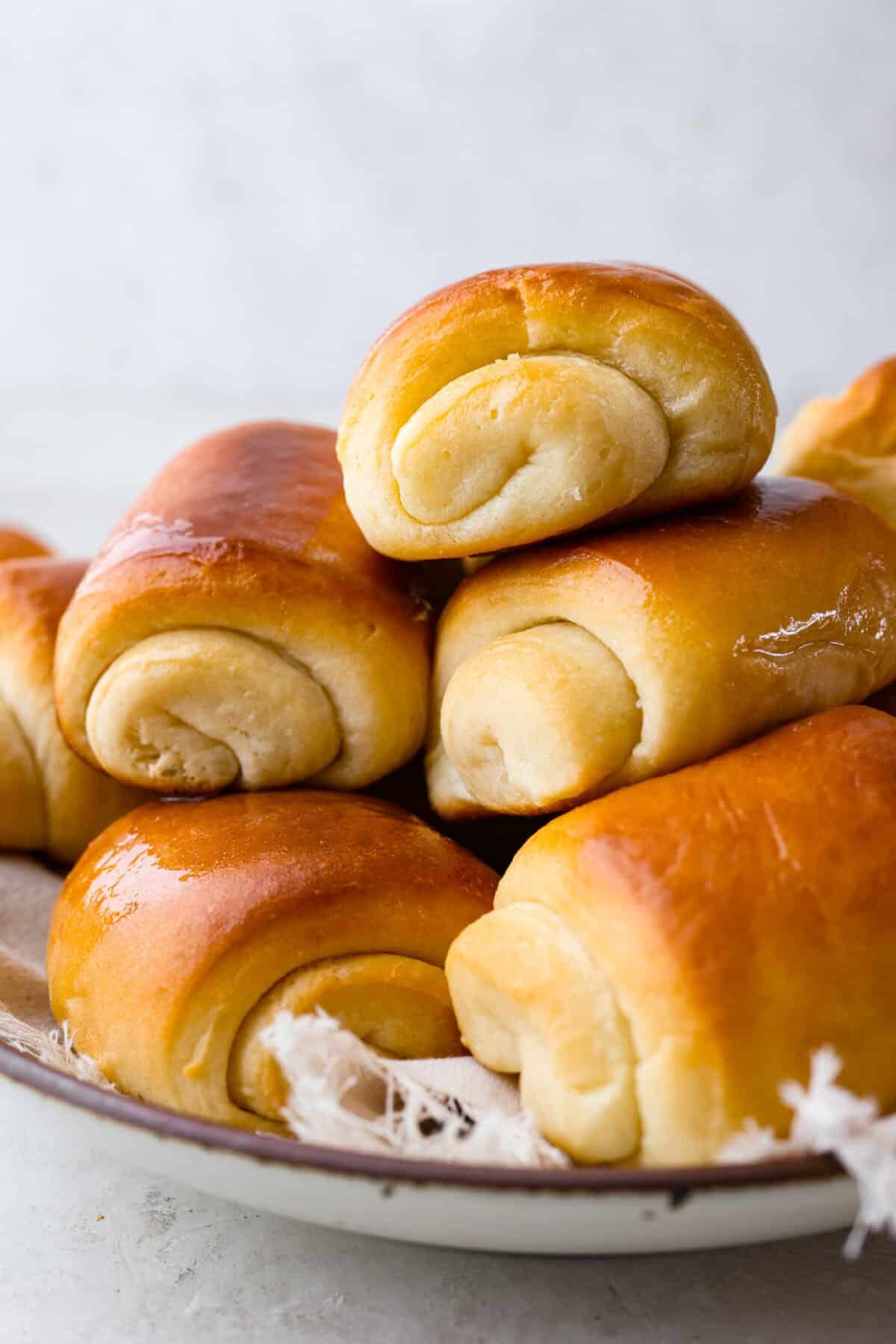 Angle shot of stacked lion house rolls. 