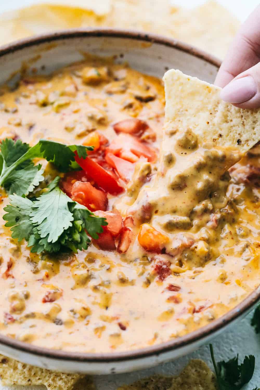 Using a corn chip to dip into the Rotel Dip.