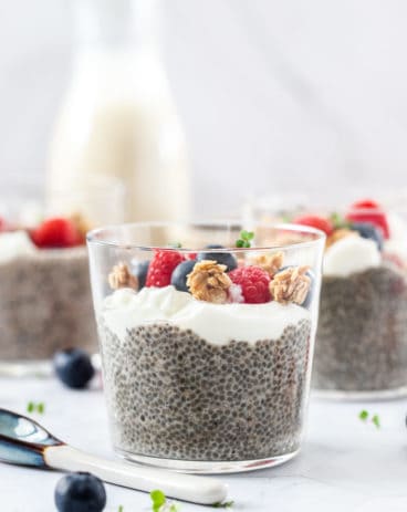 Closeup of a glass filled with chia pudding, yoghurt and berries