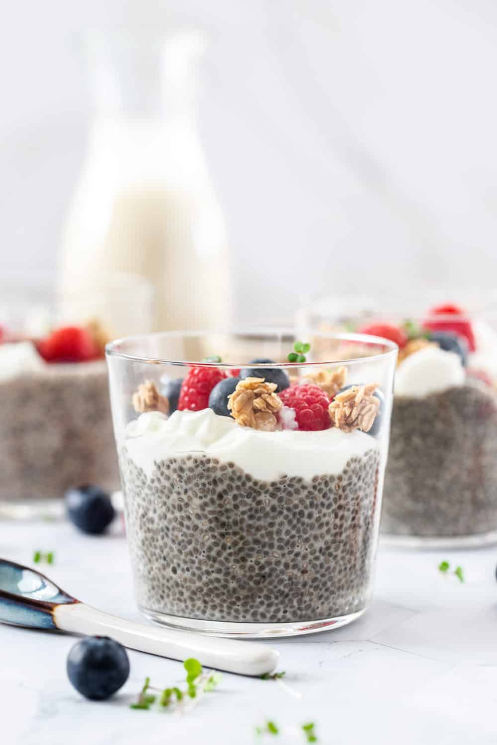 Closeup of a glass filled with chia pudding, yoghurt and berries