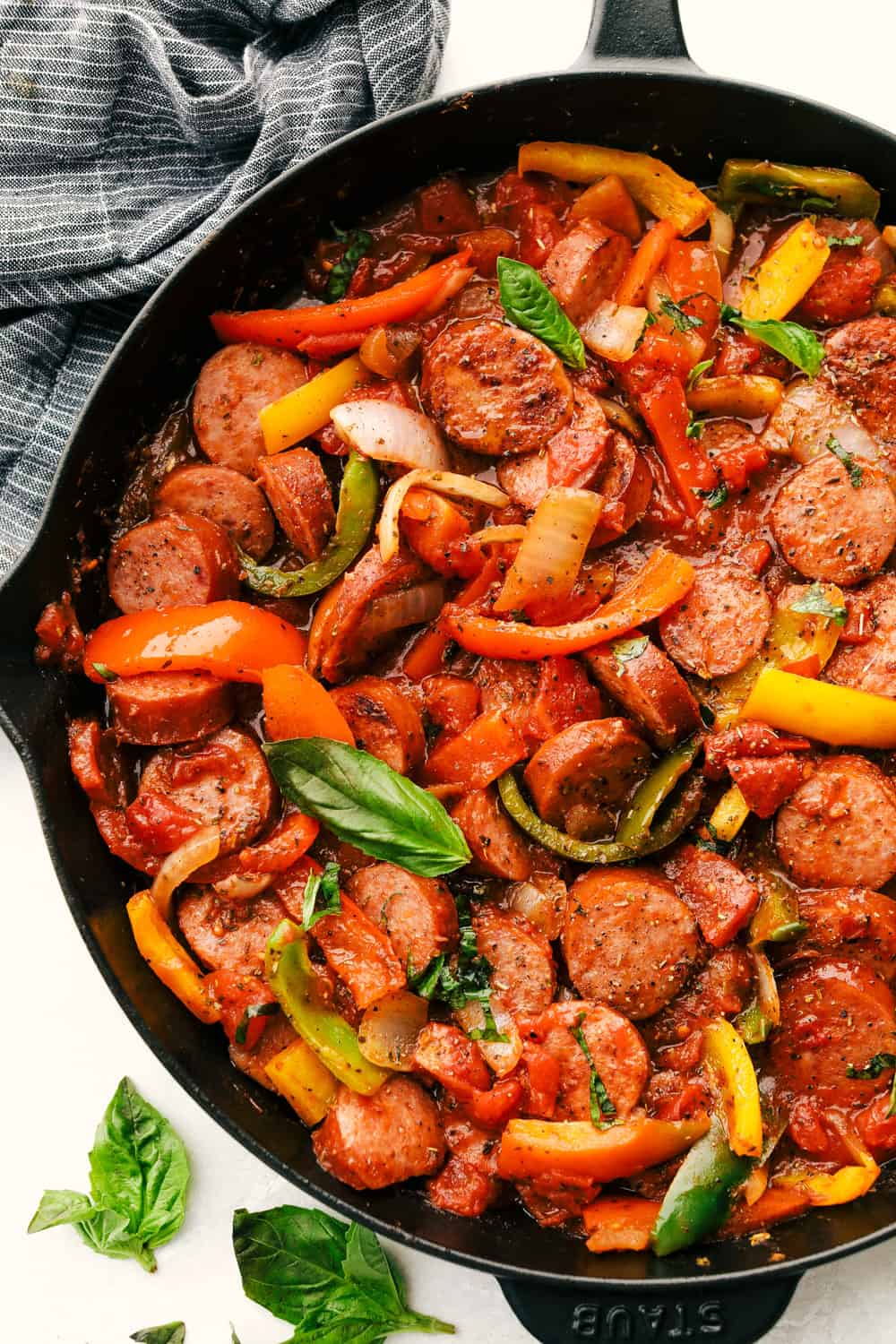 Skillet Italian sausage with peppers in a cast iron pan. 