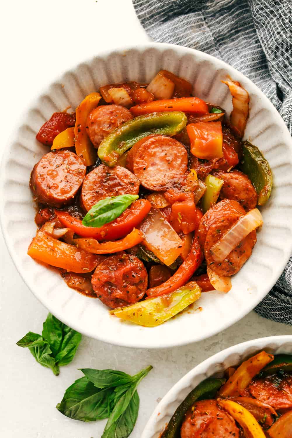 Skillet Italian sausage and peppers in a white bowl. 