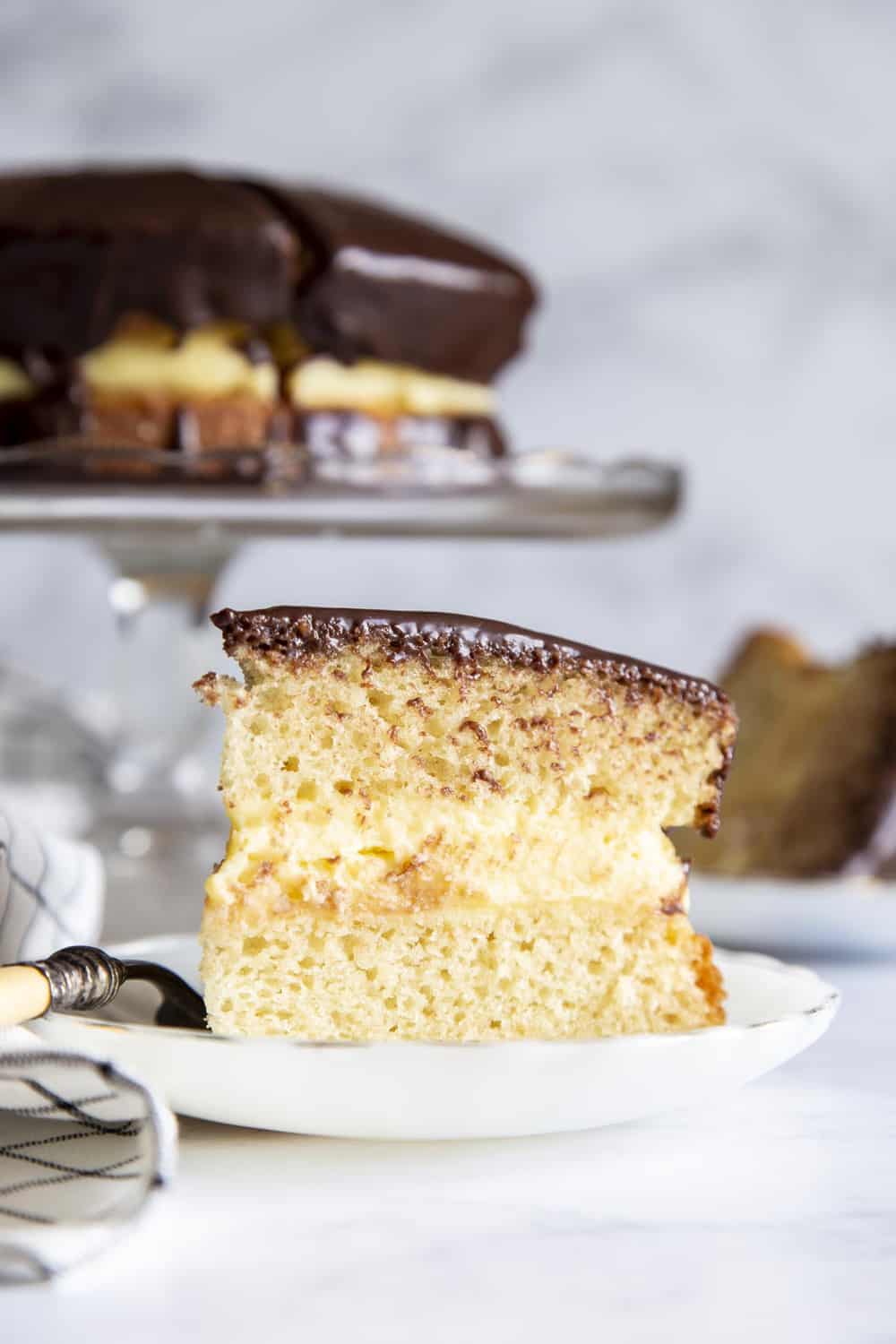 A slice of Boston Cream Cake on a plate. 