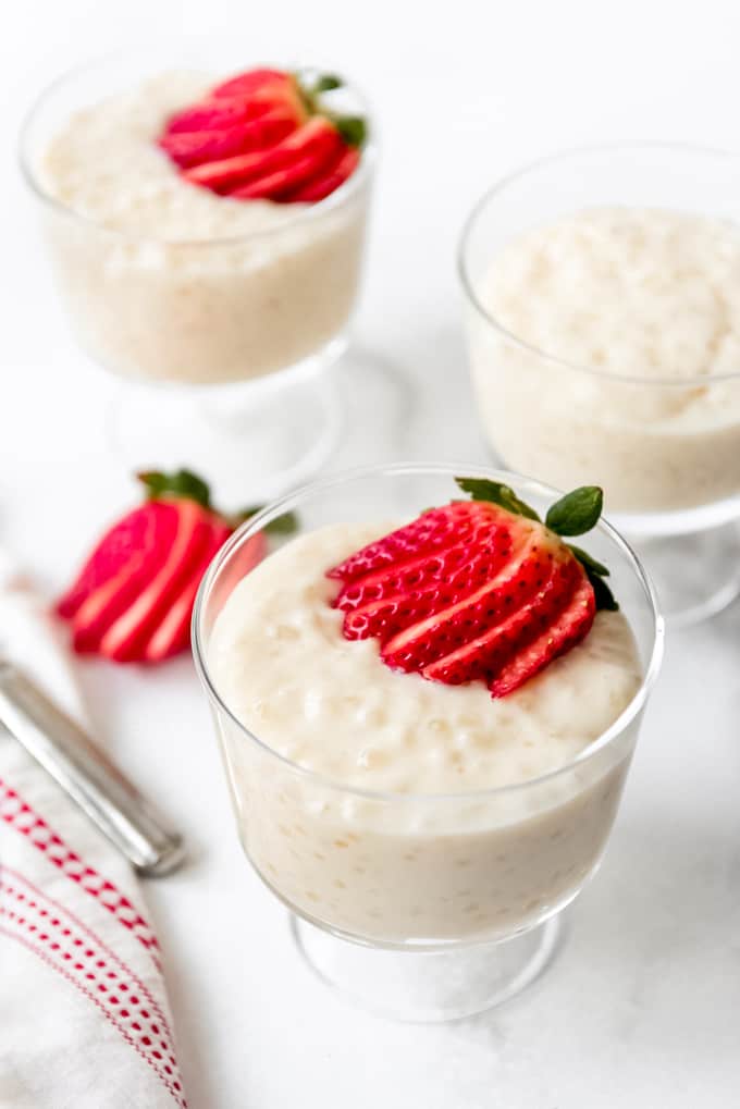 A fanned strawberry on top of homemade tapioca pudding.