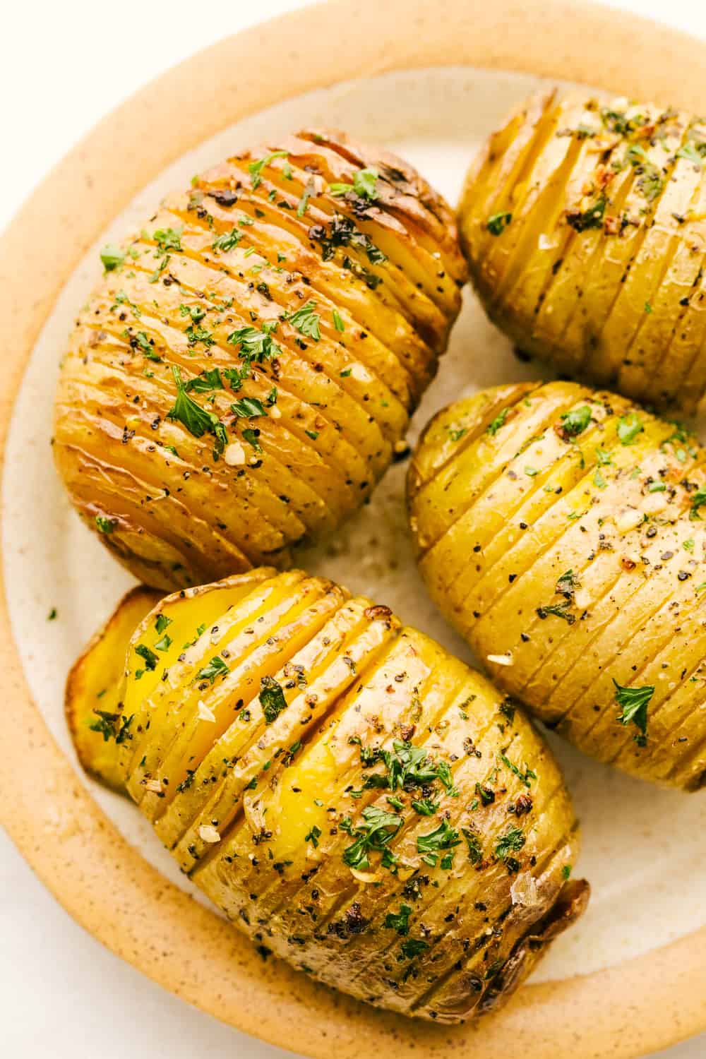 Crispy air fryer hasselback potatoes on a plate. 