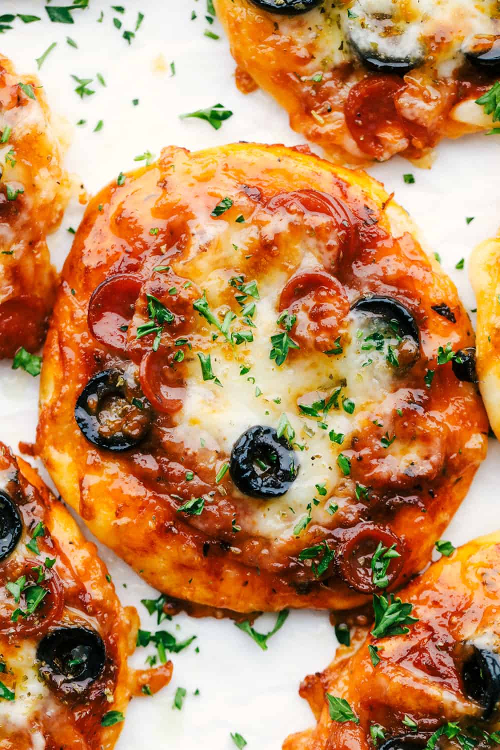 Biscuit Pan Pizza On A Plate With Pepperoni Cheese And Olives. 