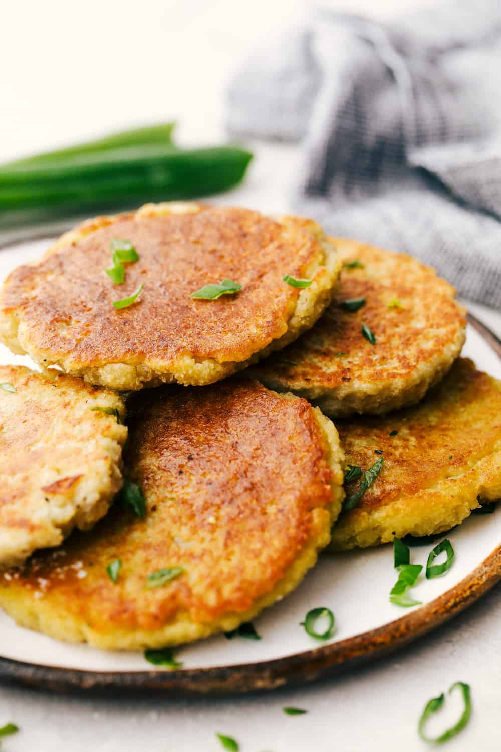 Potato pancakes with some garnish on a plate. 