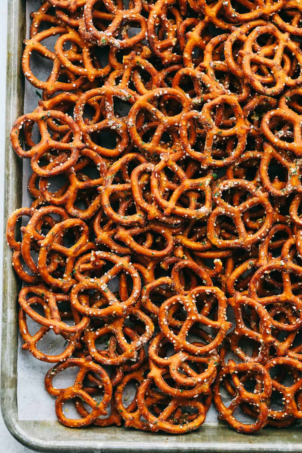Ranch covered pretzels on a cookie sheet. 