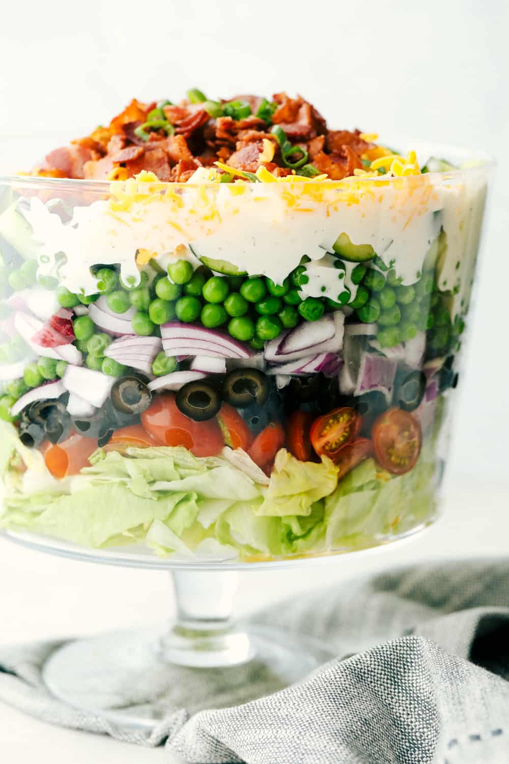 7 Layer salad with lettuce, peas and topped with bacon. 