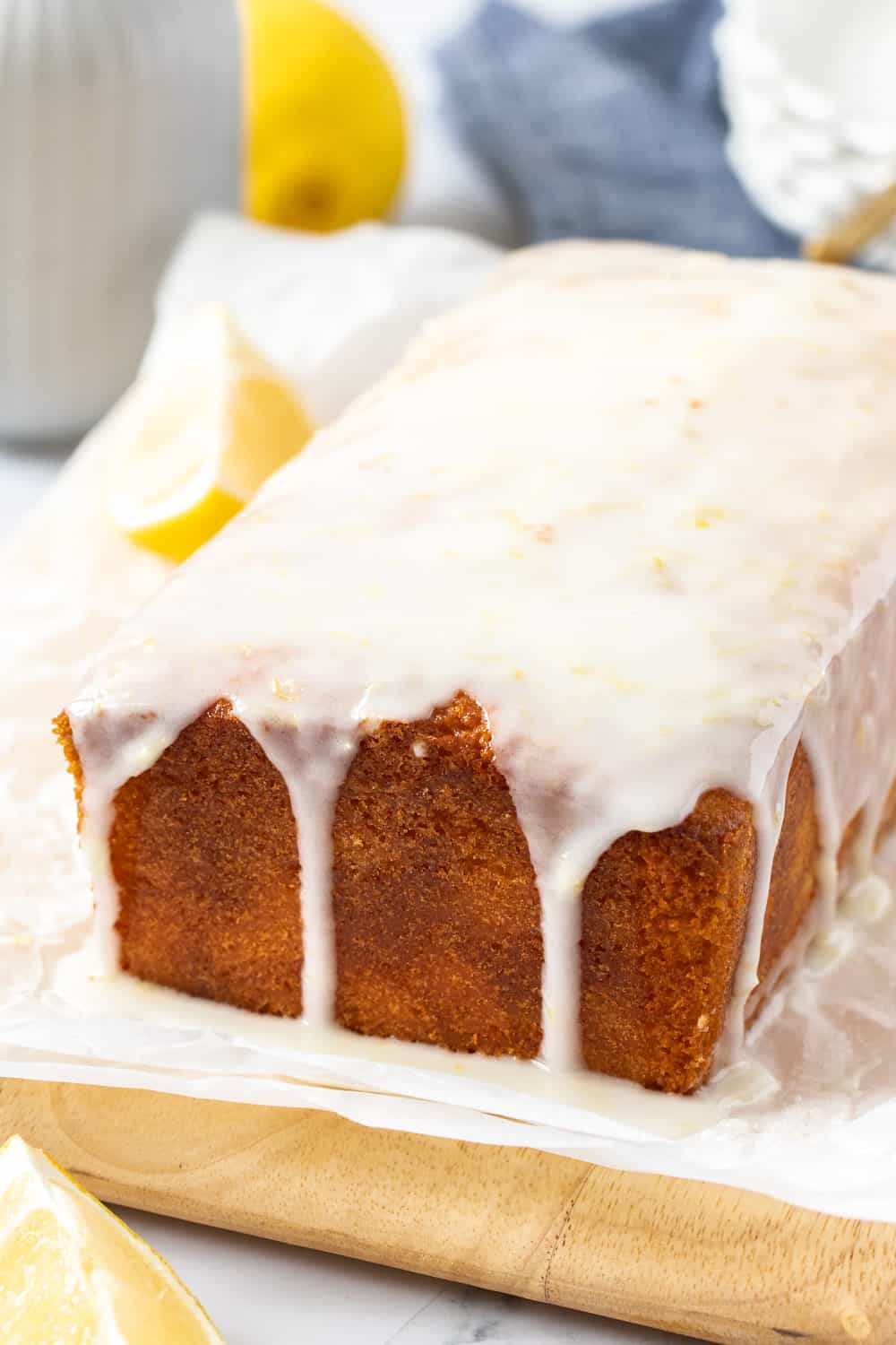 A loaf cake with glaze dripping down the sides.