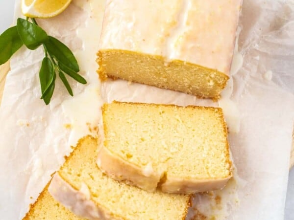 Birdseye view of a glazed cake on a sheet of baking paper.
