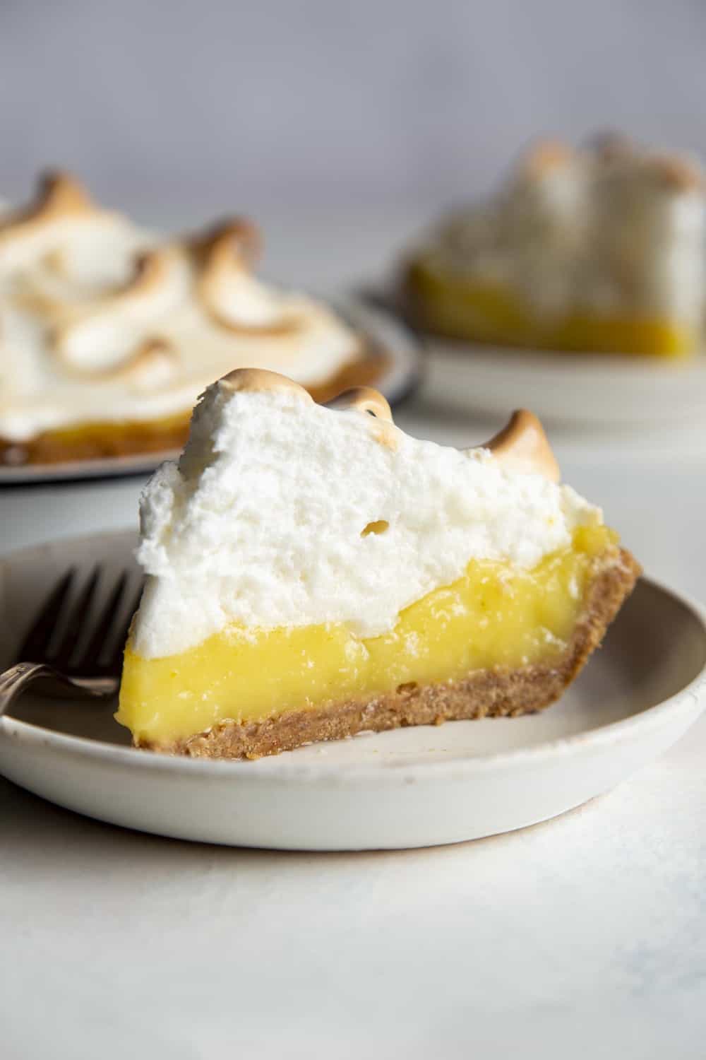 Slice of Lemon Meringue pie on a plate.