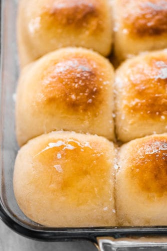 A close up of potato rolls in a pan.