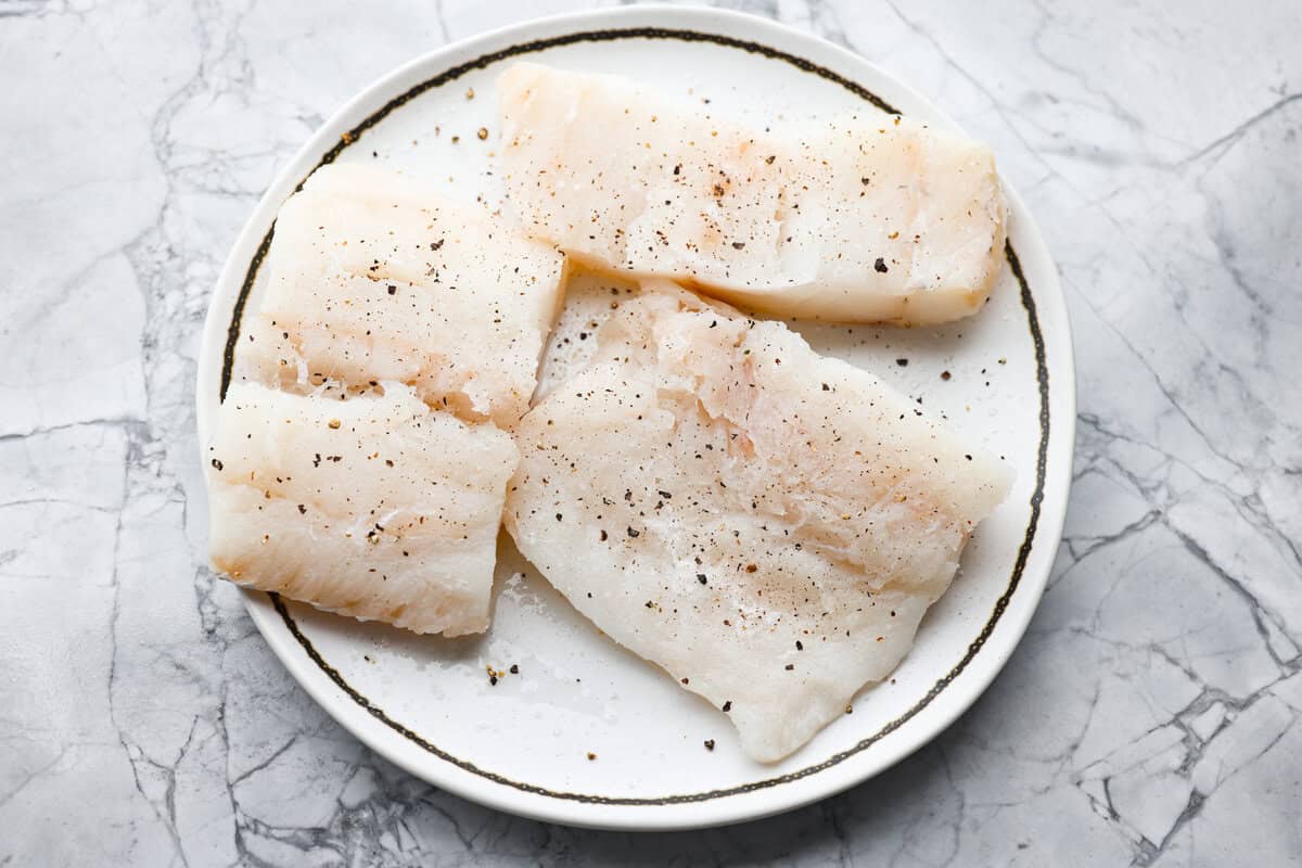 Air Fryer Cod undergoing crisping in the basket