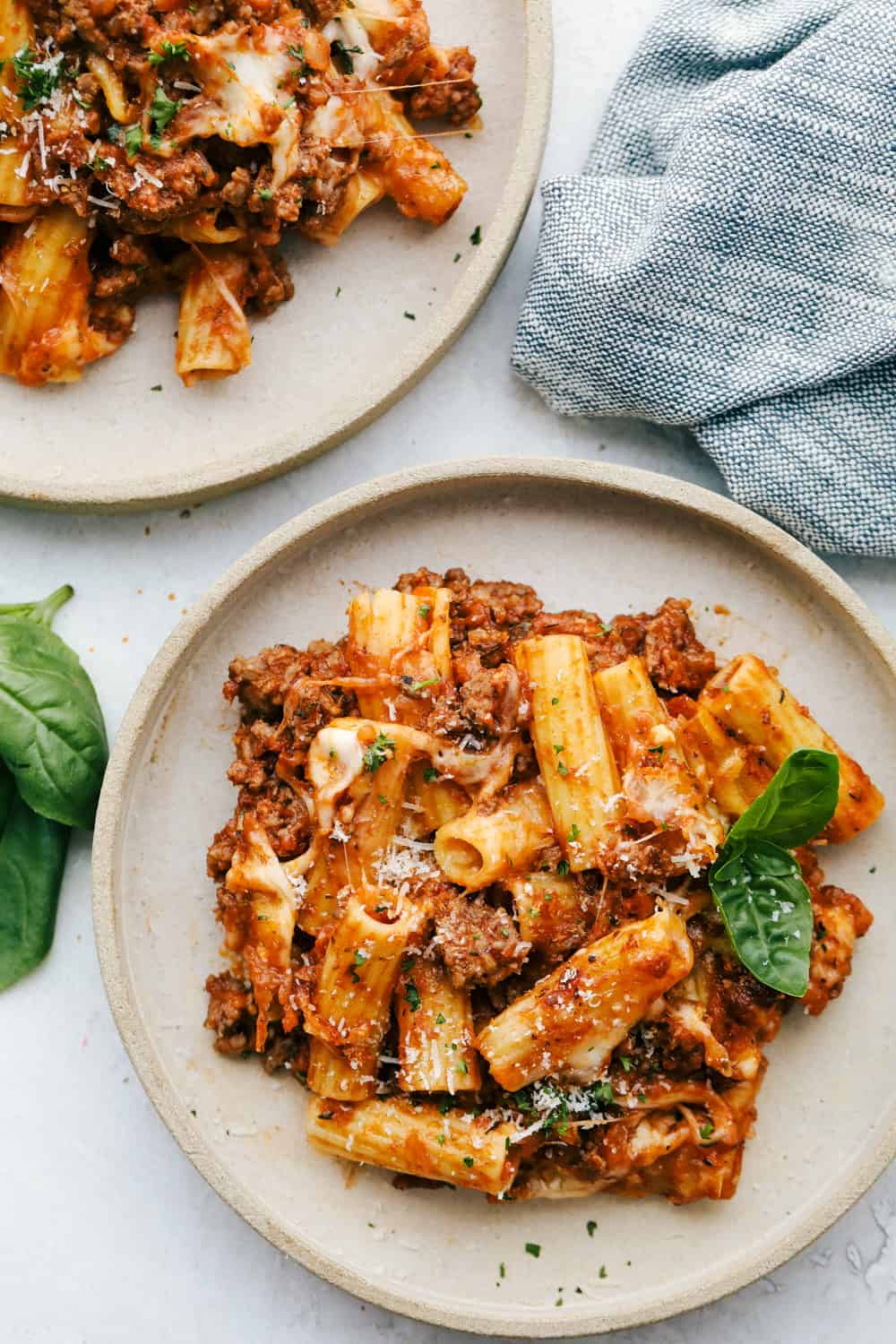 Two plates with baked rigatoni. 