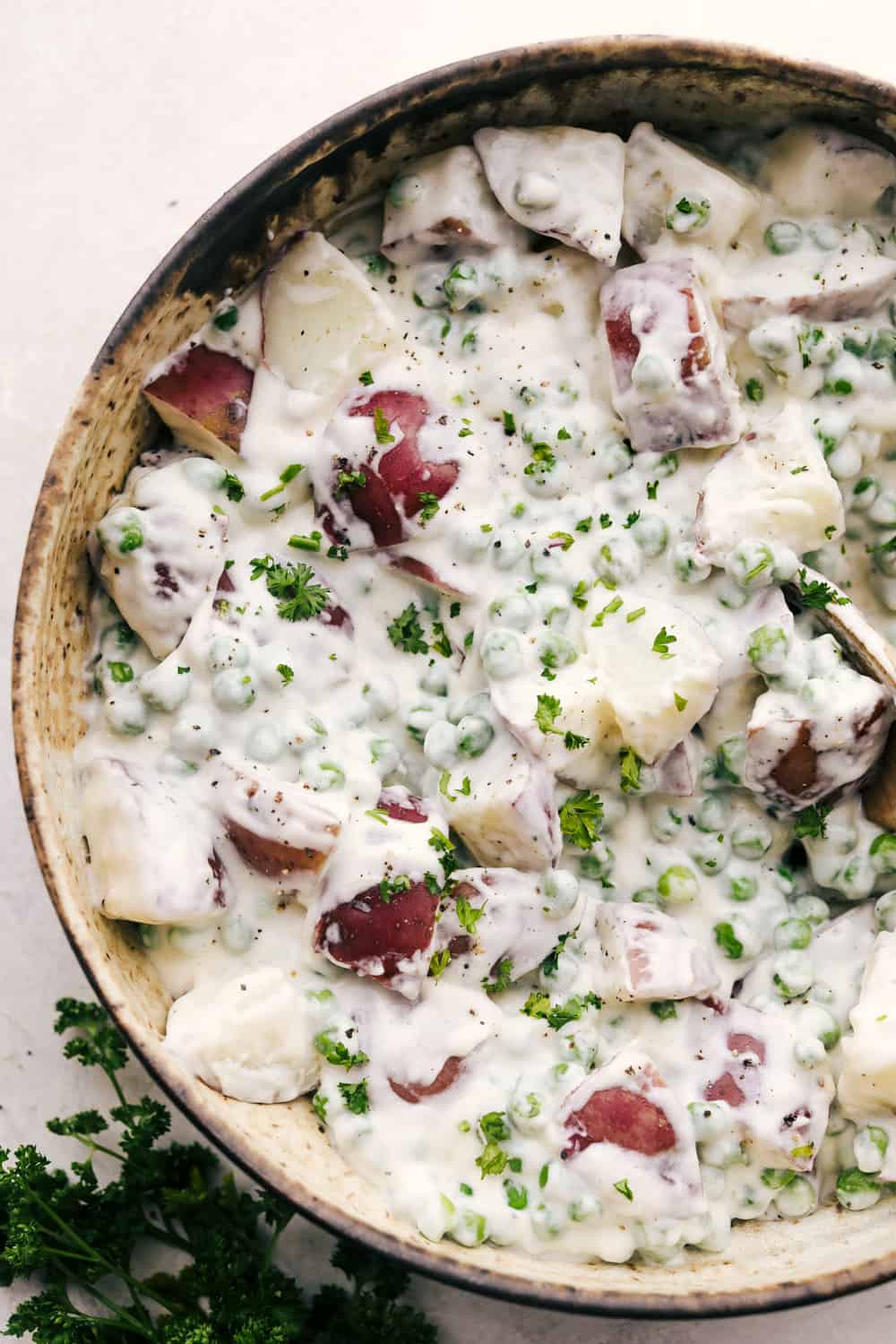 Creamed potatoes and peas in a bowl ready to eat. 