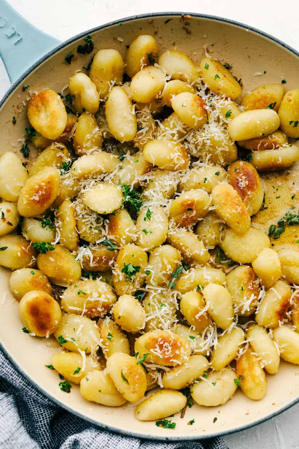 Fried gnocchi with browned butter in a skillet. 