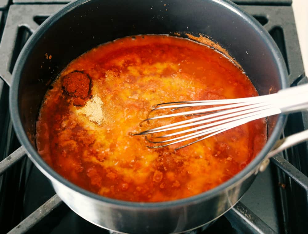 Cooking the buffalo sauce in pot on the stove.