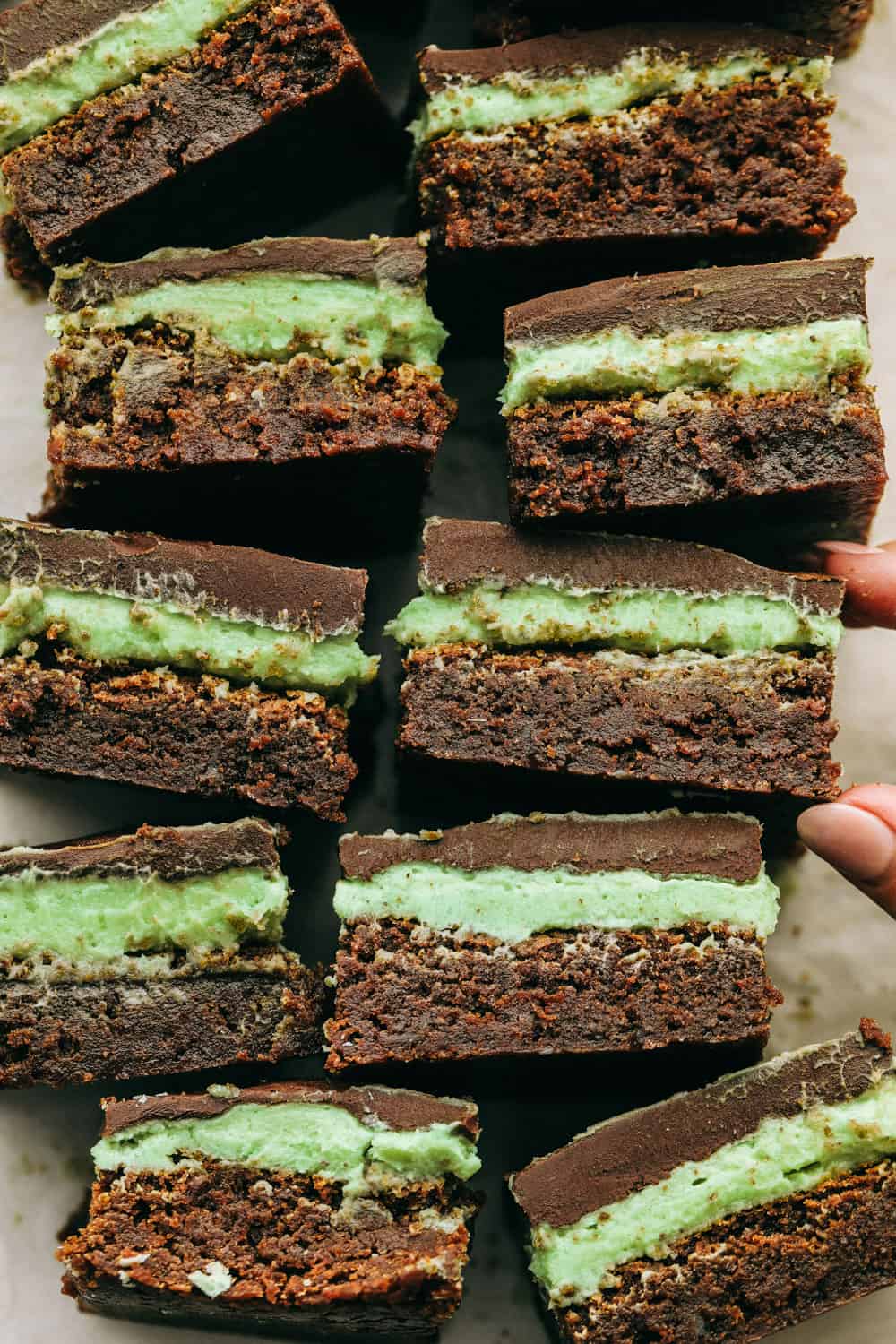 Mint brownies on their sides showing the layers. 