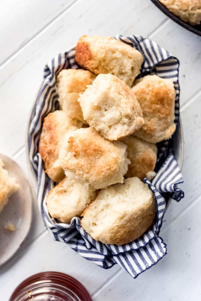 angel biscuits in a bowl with a striped linen napkin