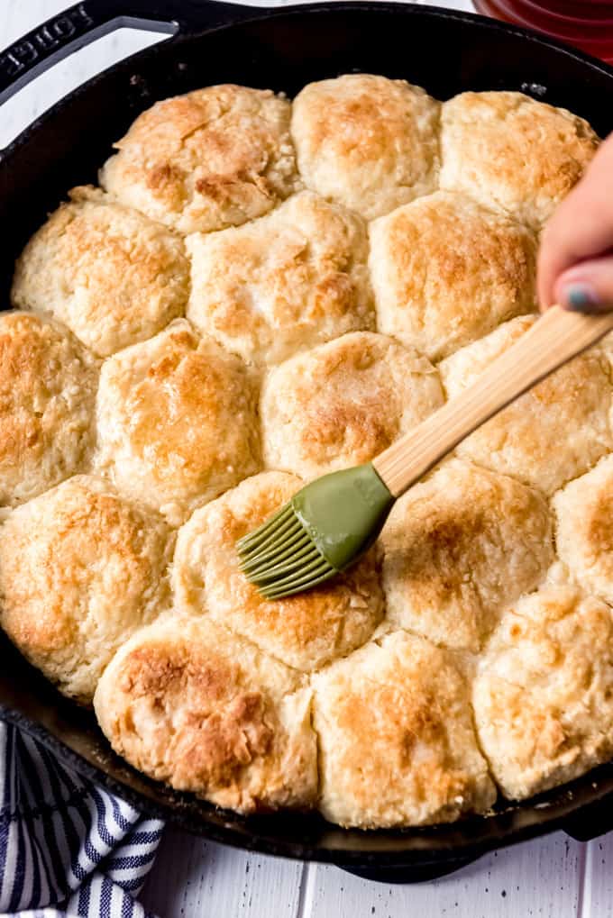 brushing the tops of angel biscuits with melted butter