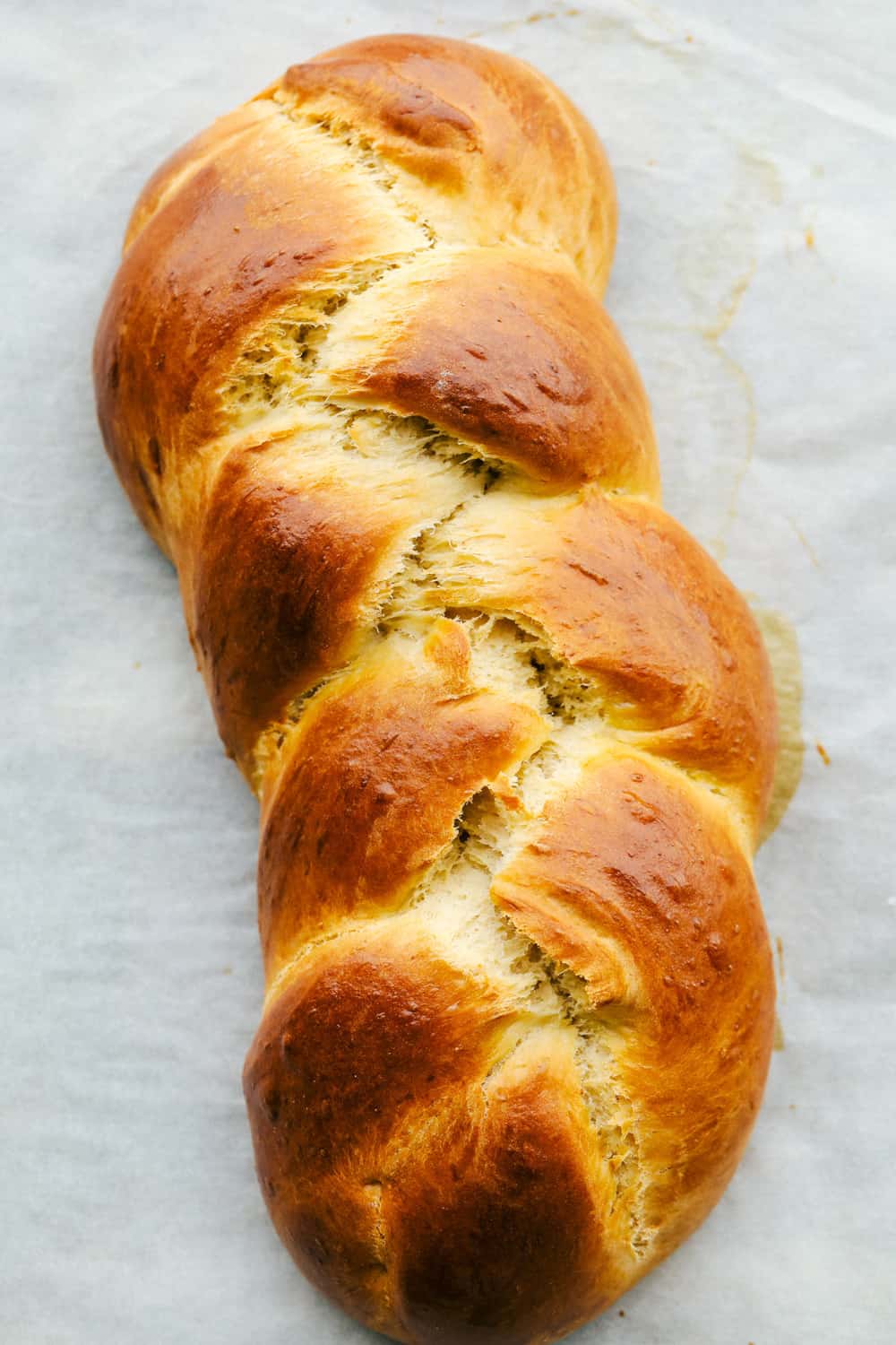 Golden brown baked challah bread. 
