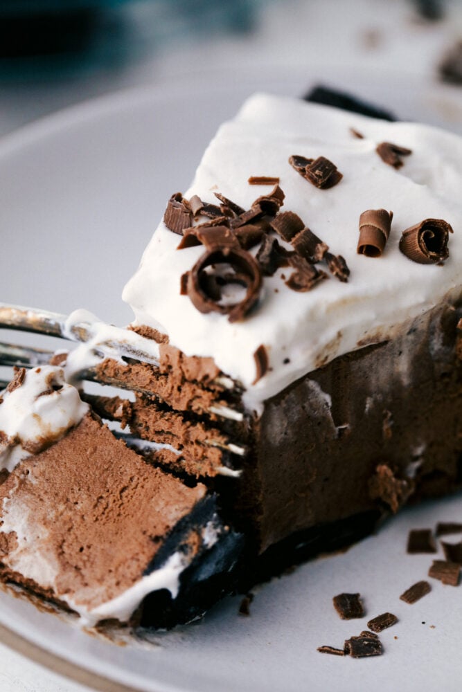 A fork cutting into a slice of chocolate pie. 