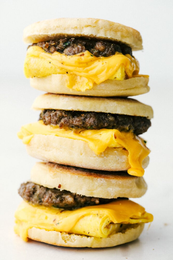 English muffin breakfast sandwiches stacked on top of each other. 