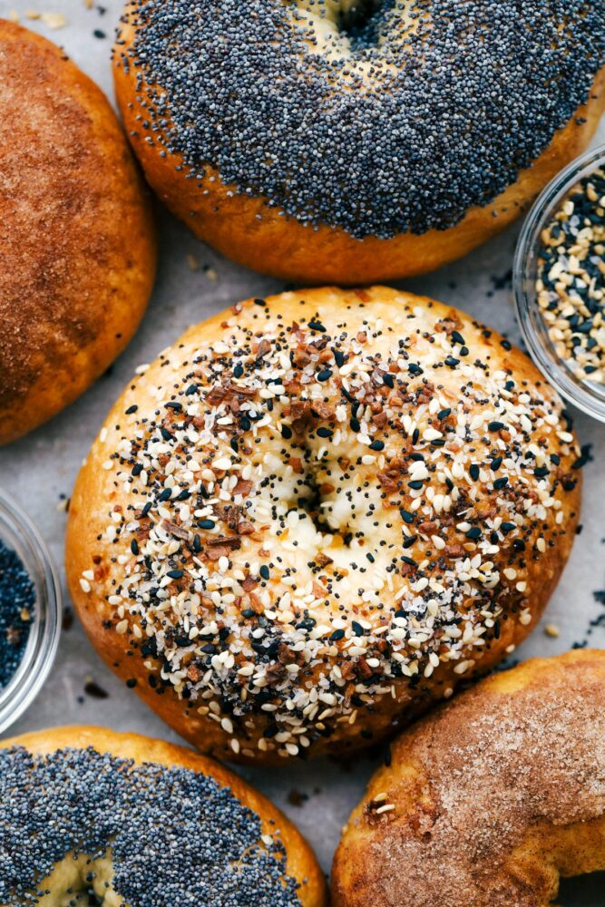 Up close picture of two bagels with poppy seed and everything seasoning.