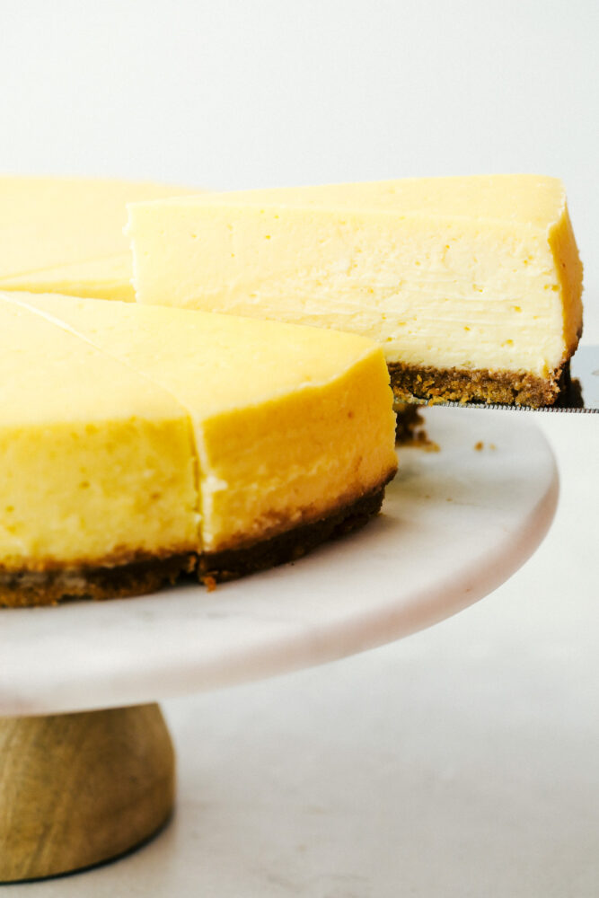 A slice of New York cheesecake being served. 