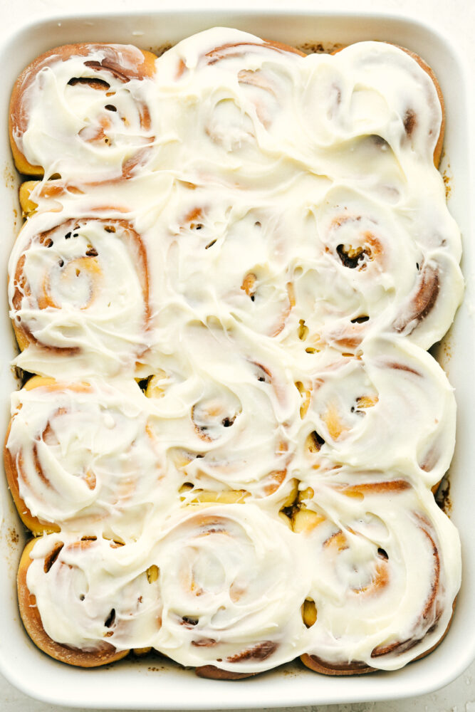 Cinnamon rolls covered in cream cheese frosting. 