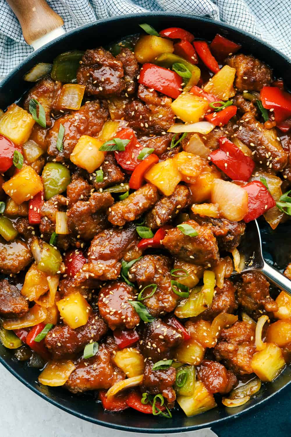 A skillet of sweet and sour pork with ready-to-serve seeds. 