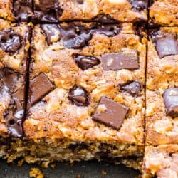 Oatmeal chocolate chip bars in a baking dish with a few missing.