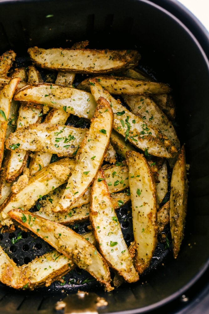 Cooked potato wedges in the air fryer ready to eat. 