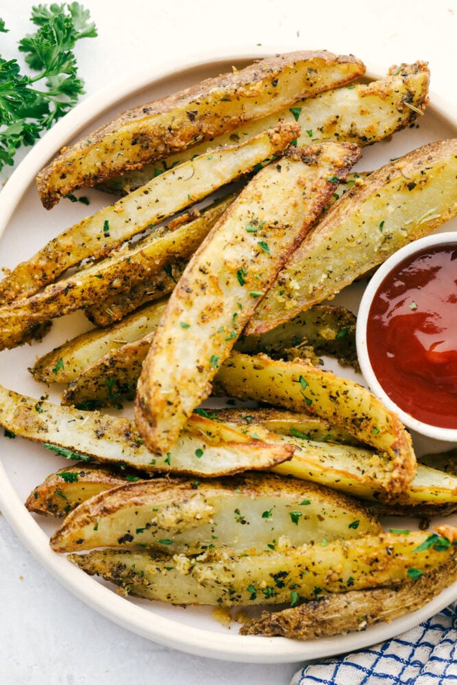 Air Fryer potato wedges on a plate with ketchup. 