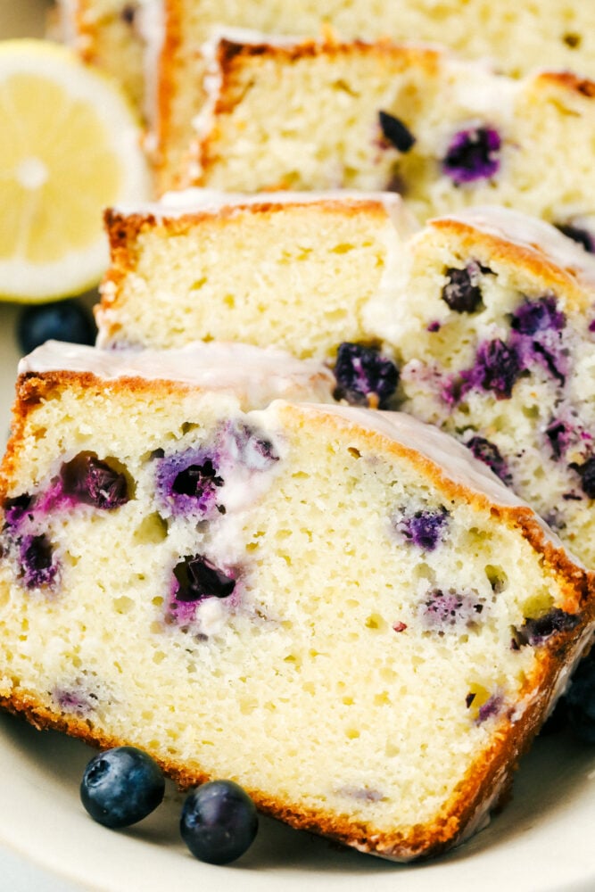 Sliced blueberry lemon pound cake on a plate. 