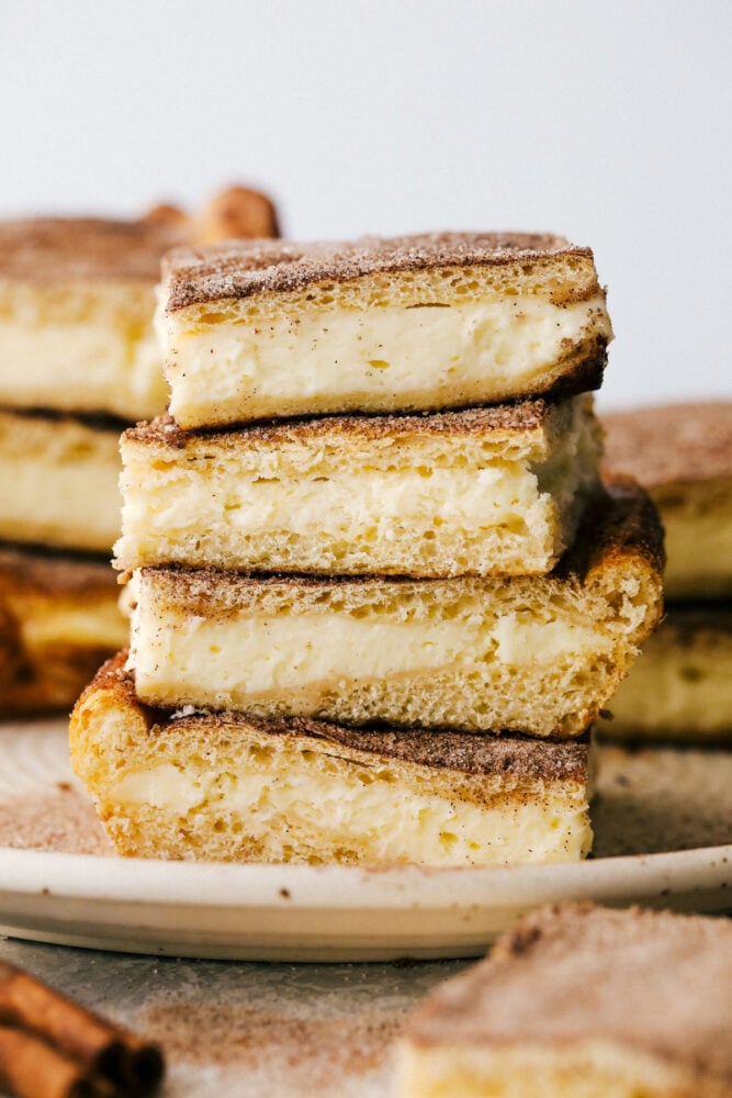 Churro Cheesecakes bars stacked on top of eachother. 