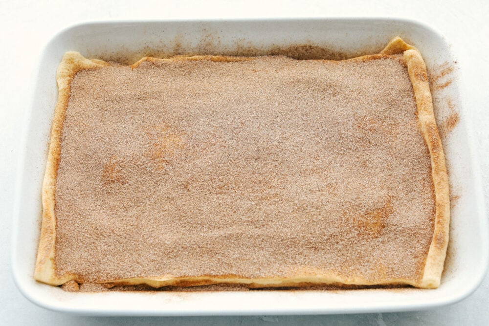 Covering the top with cinnamon and sugar.