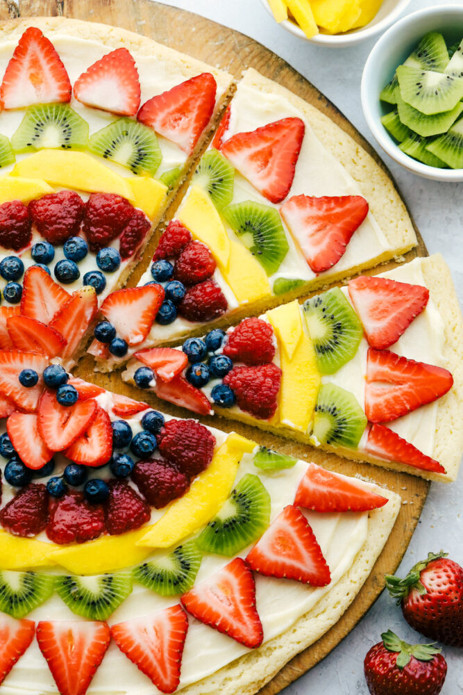 Fruit pizza cut into slices. 