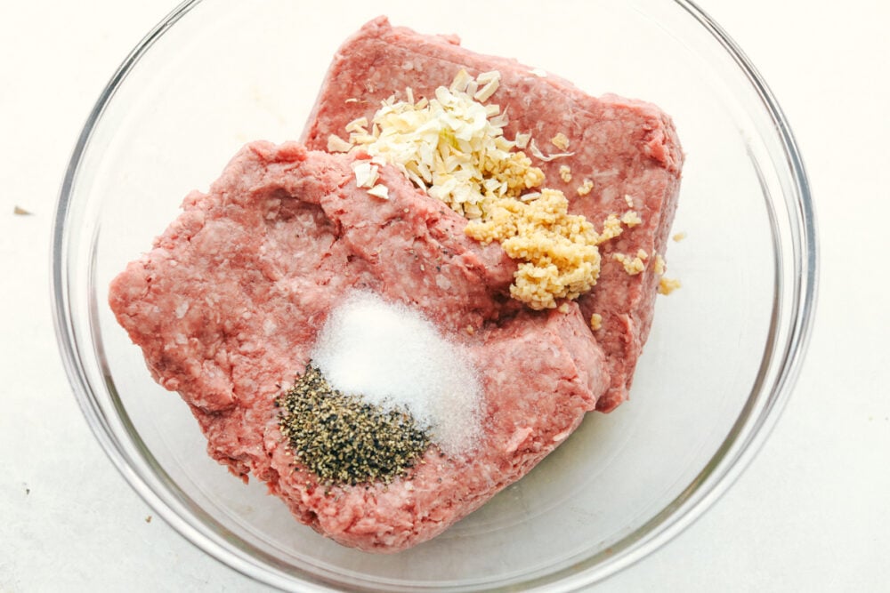 All the hamburger ingredients in a bowl ready to be mixed. 