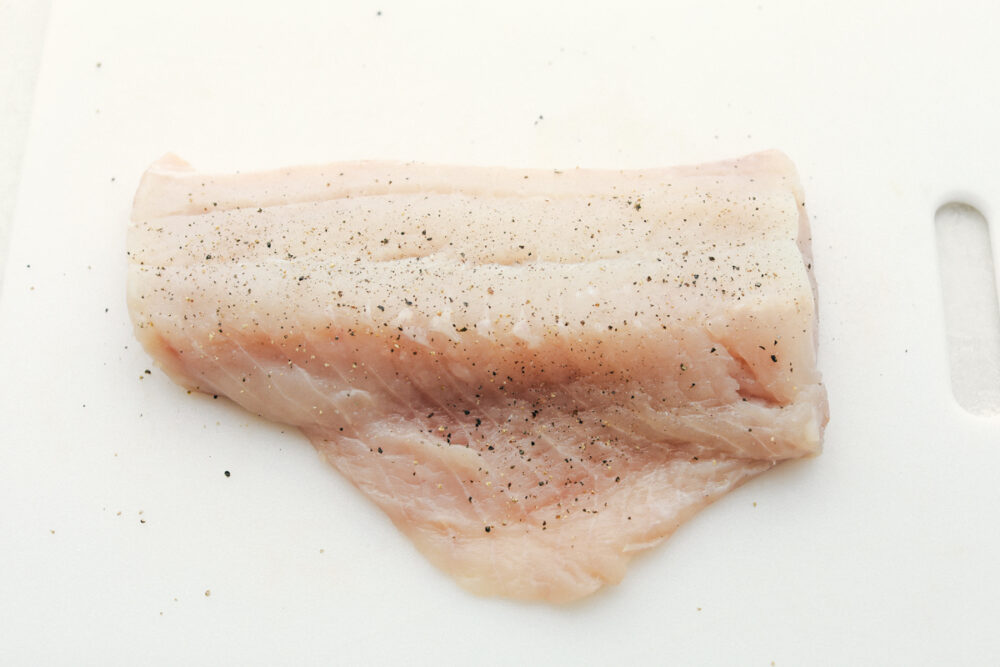 Seasoning raw cod. 