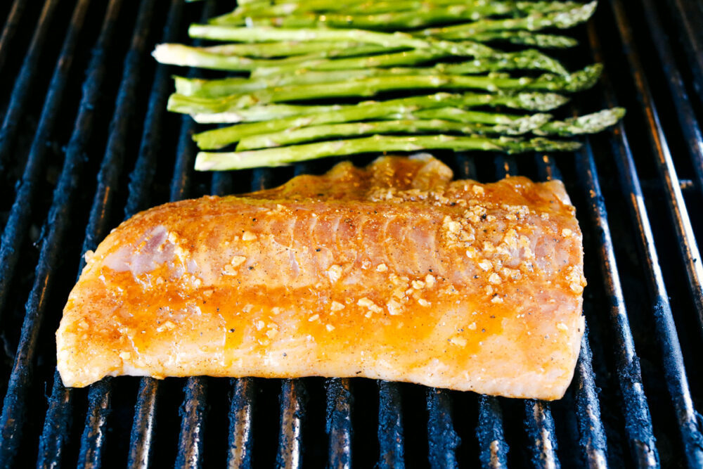 Cod and Asparagus on the grill cooking. 