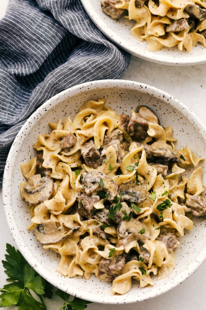 A serving of Instant pot stroganoff in a bowl garnished with parsley. 