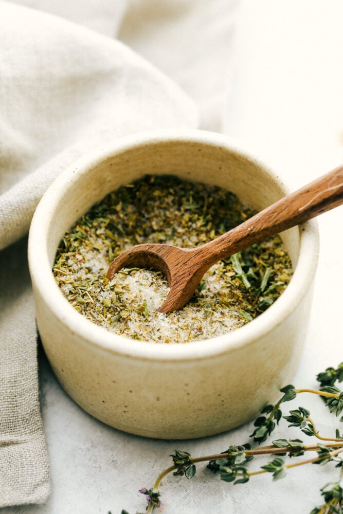 Italian dressing mix in a bowl with a tiny spoon.