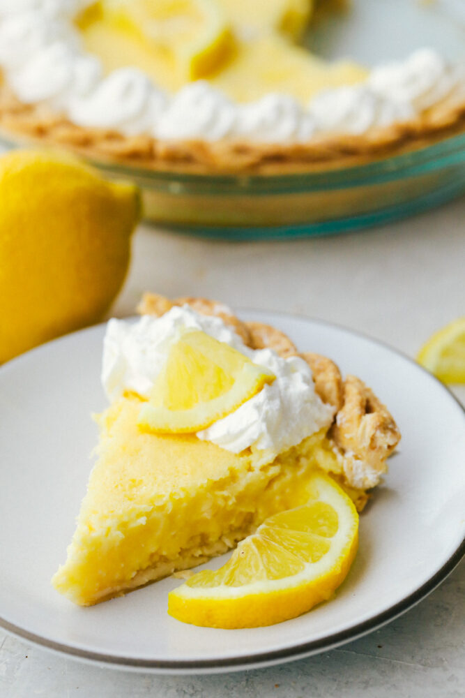 A slice of lemon pie on a plate. 