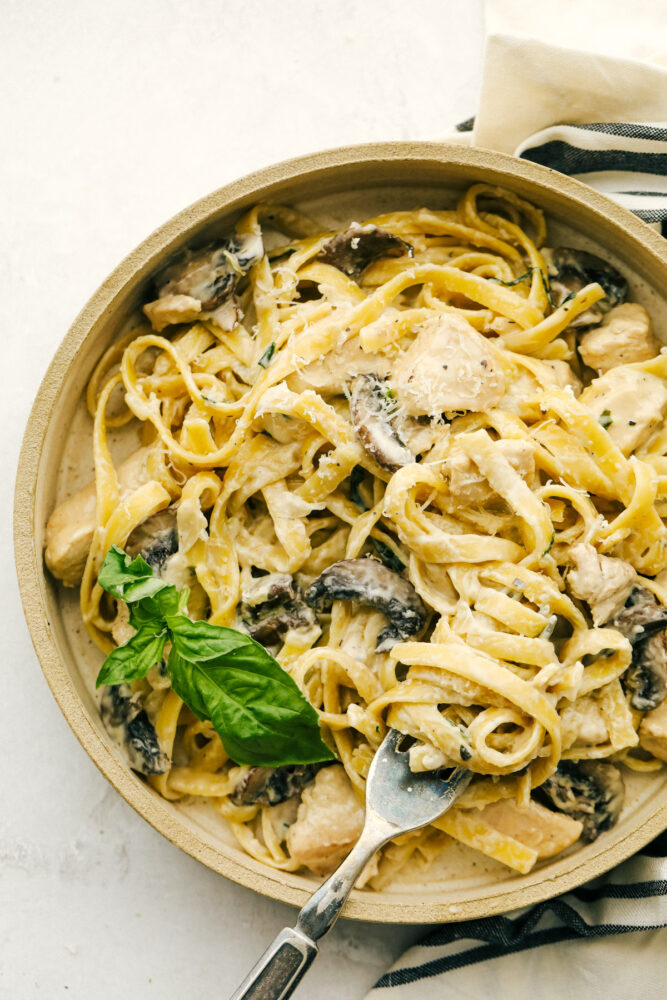 Chicken and Mushroom Fettuccine Alfredo is an easy weeknight or weekend meal made even faster if you have leftover chicken. One-pot means keeping this simple while everything is simmered together.