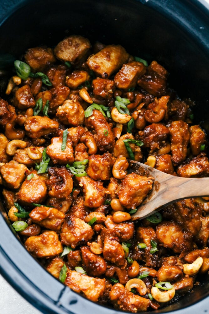 Stirring the cashew chicken in the slow cooker. 