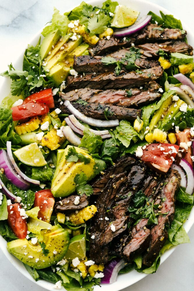 Skirt steak tossed in a salad with assorted vegetables.